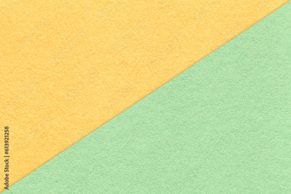 Texture of craft light yellow and green paper background, half two colors, macro. Vintage mint and ocher cardboard. Texture of craft light yellow and green paper background, half two colors, macro. Vintage mint and ocher cardboard.