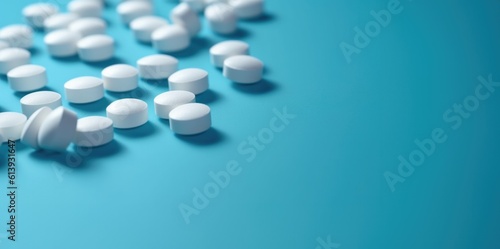 White pills on blue background. Offset left. photo