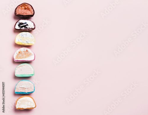 Japanese dessert mochi on a pink background with copy space. mochi with various filling. 