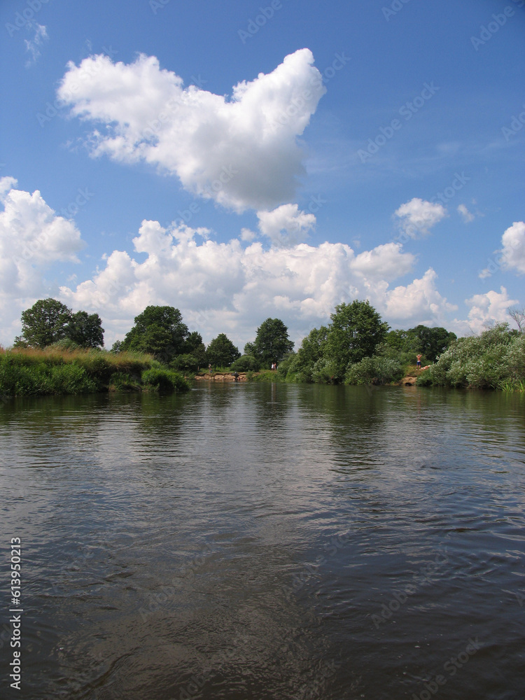 Obraz premium Landscape, view of the lake and the shore, green trees and water surface