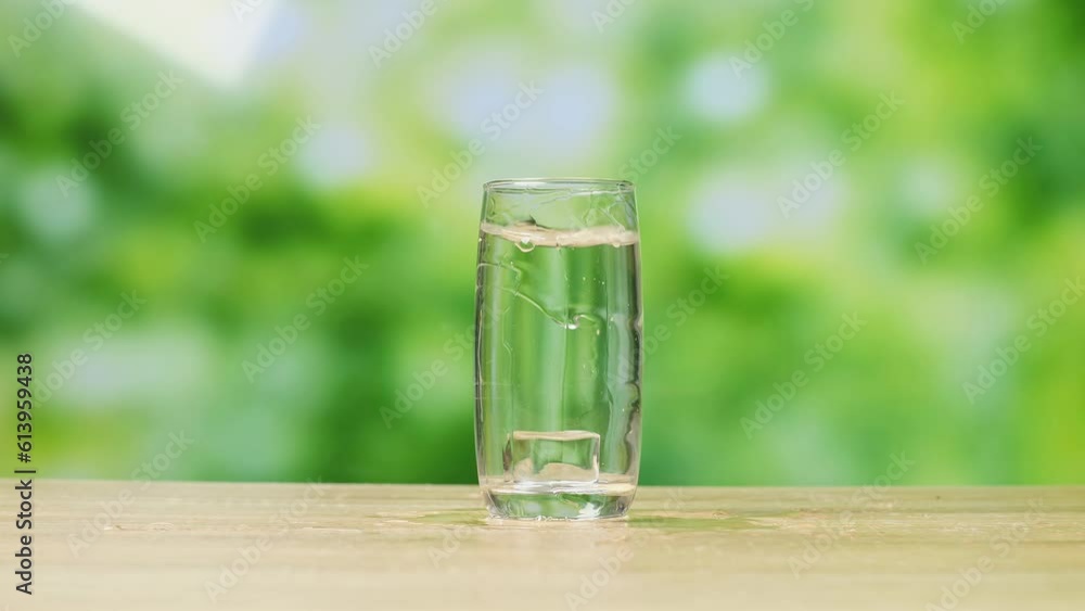 Ice Cube Falling In A Glass Of Drinking Water On Bur Nature Screen Background In The Studio
Ice Cube Falling In A Glass Of Drinking Water On Bur Nature Screen Background In The Studio