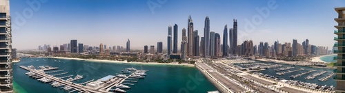 Panoramic aerial view of Dubai beachfront modern skyscrapers sunshine summer day. Backdrop of cityscape UAE skyscrapers and new towers. Construction and modern architecture concept. Copy ad text space © Alex Vog