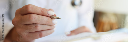 Hands of cardiologist or pediatrician doctor take notes with pen with medical letter