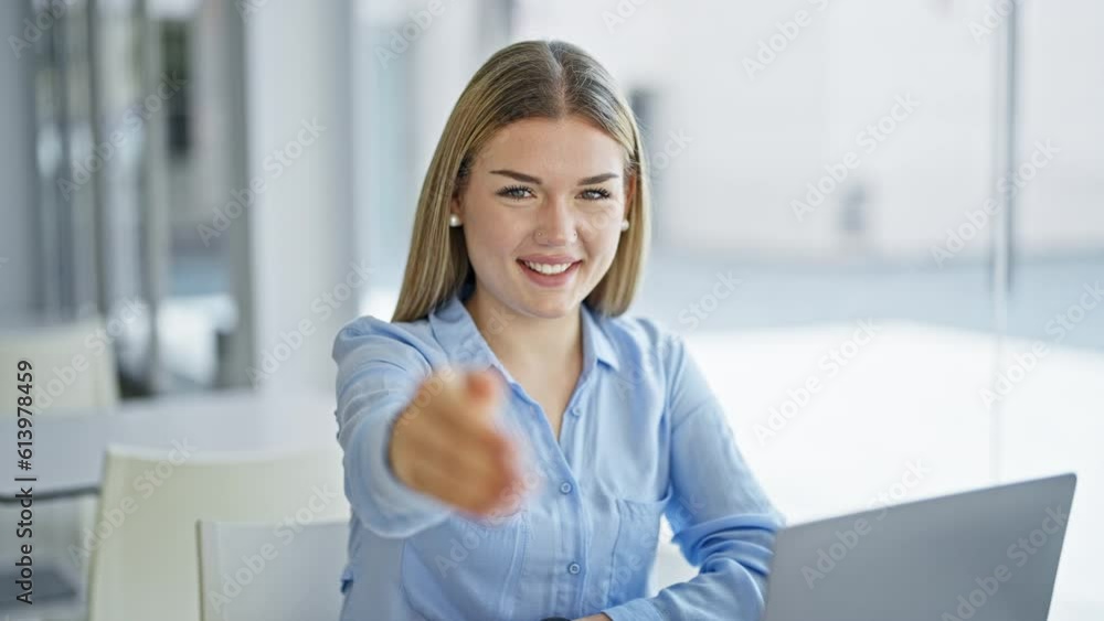 Young blonde woman business worker using laptop shake hand at office Young blonde woman business worker using laptop shake hand at office
