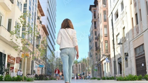 Woman walking on a street in Alicante, Spain