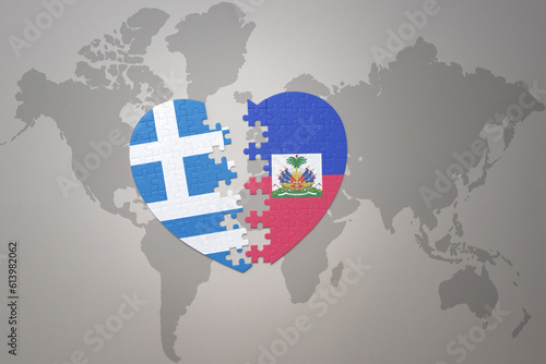 puzzle heart with the national flag of haiti and greece on a world map background.Concept.