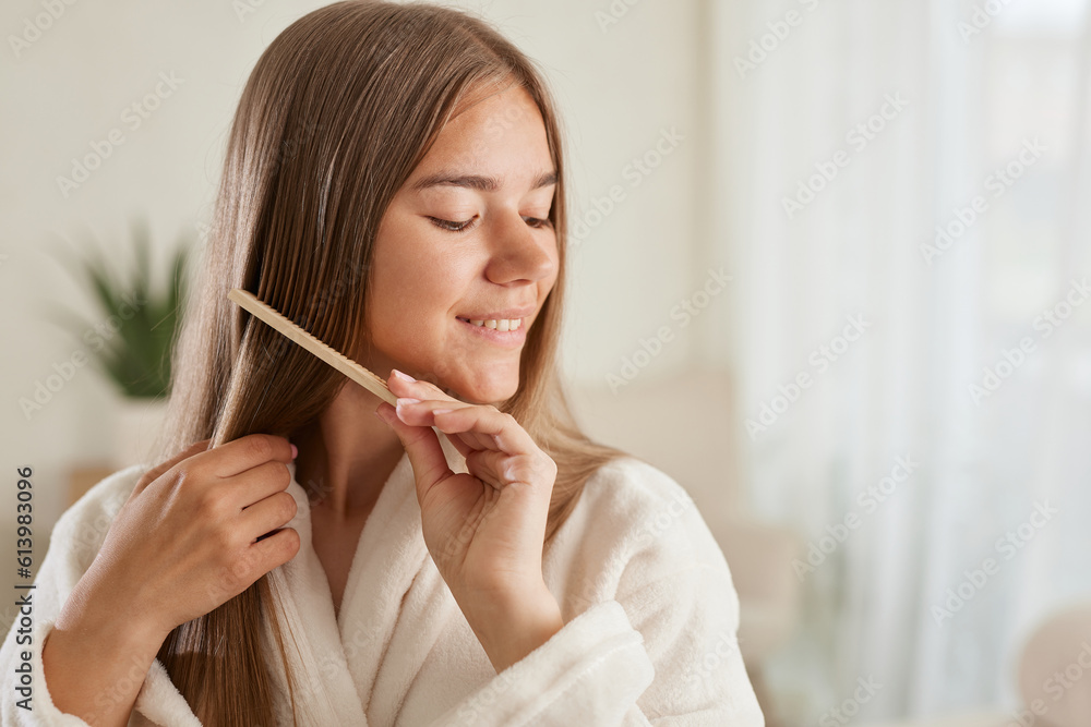 a young girl in a white coat takes care of her hair at home a young girl in a white coat takes care of her hair at home