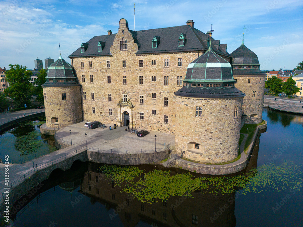 Orebro, Sweden, June 16th 2023. A drone photo of Orebro castle on Svartan river early in the morning.