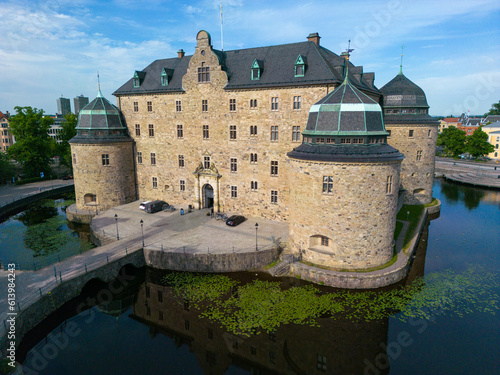 Orebro, Sweden, June 16th 2023. A drone photo of Orebro castle on Svartan river early in the morning. photo