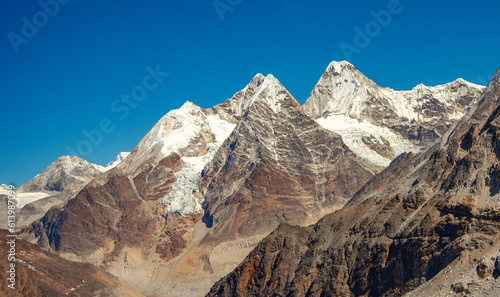 High snow capped mountains with blue sky
