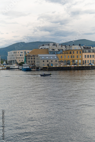 Boat setting sail at sunset. Boat going through water channel in town