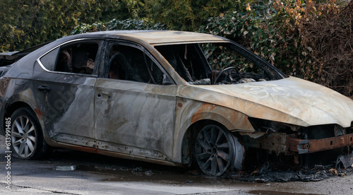 Burnt car wreckage, destroyed by arsonists. Vandalism.