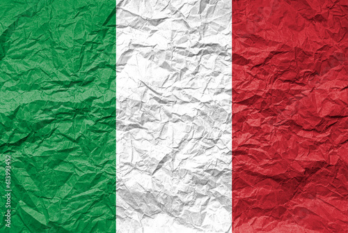 Flag of Italy on crumpled paper. Textured background.