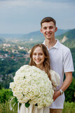 Portrait of a young couple after a marriage proposal in the mountains