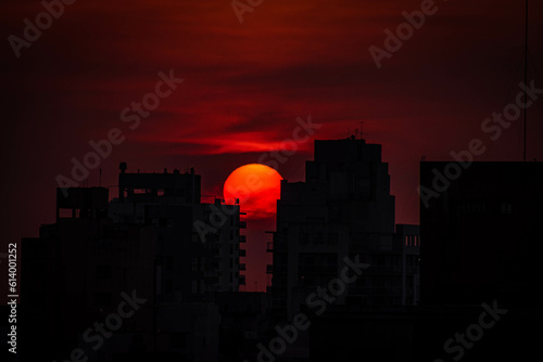 El sol se posa entre 2 edificios al atardecer