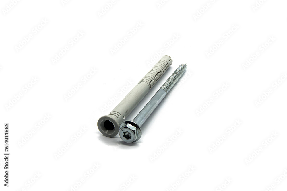 A plastic dowel with a metal screw on a boom background A plastic dowel with a metal screw on a boom background