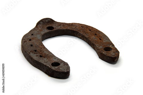 Metal horseshoe covered with rust on a white background