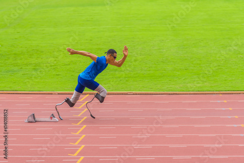 Athlete with prosthetics sprints instantly from start, displaying exceptional speed on stadium track