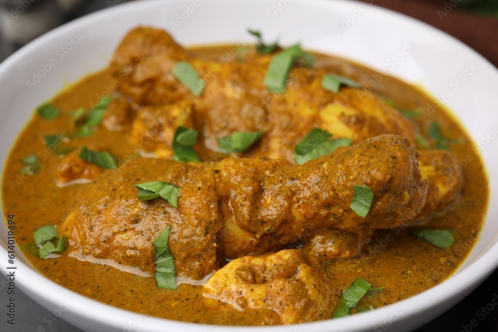 Delicious chicken with curry sauce in bowl, closeup Delicious chicken with curry sauce in bowl, closeup
