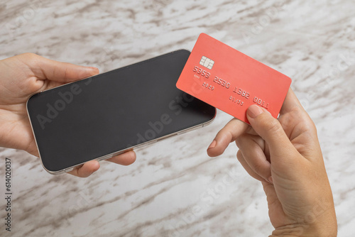 making payment with a credit card on a cell phone, mobile device and technology to make purchases, modern lifestyle photo