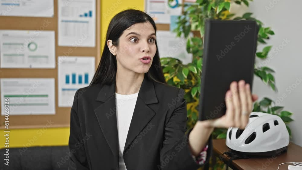 Young beautiful hispanic woman business worker smiling confident having video call at office