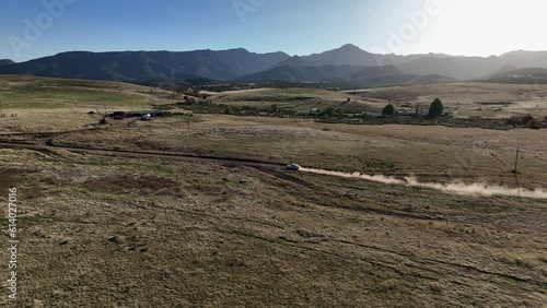 Drone shot of car driving on dirt road in Willcox, Arizona, tracking aerial shot