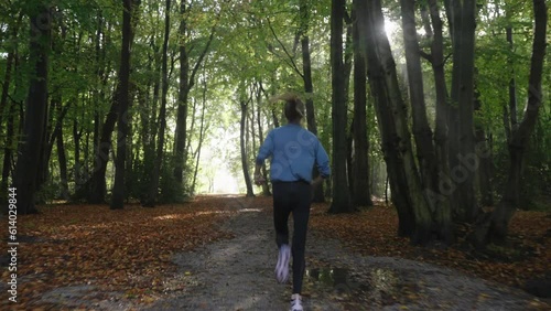Wallpaper Mural Dynamic forest run: camera follows running woman in misty morning. Sunlight streaks, serene atmosphere, fitness, outdoor exercise, nature exploration. Torontodigital.ca