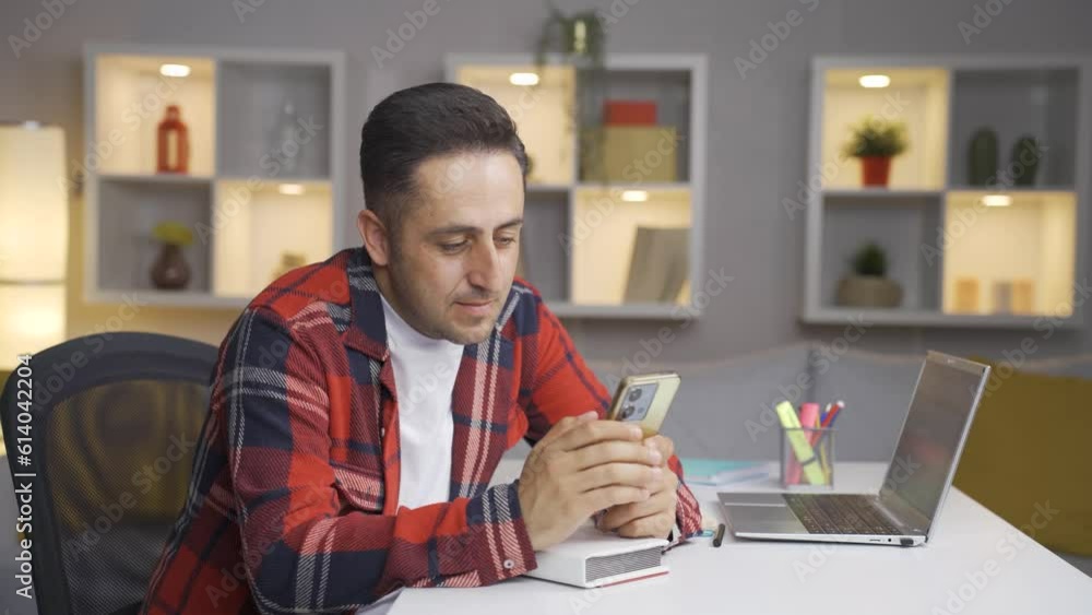 Longingly, the man looks at the photo on the phone.