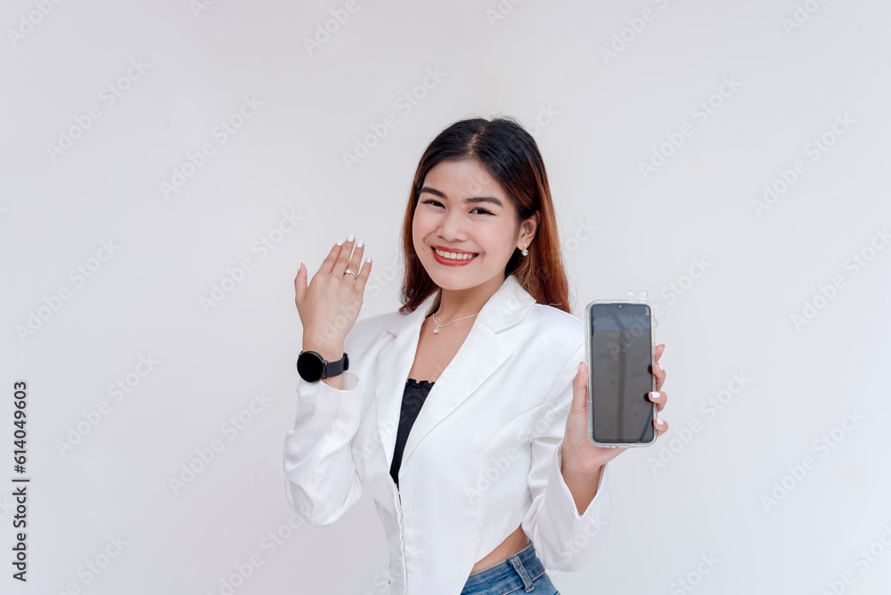 A smiling young woman posing in front of the camera with a smart phone while showing off her smart watch. Isolated on a white background. A smiling young woman posing in front of the camera with a smart phone while showing off her smart watch. Isolated on a white background.