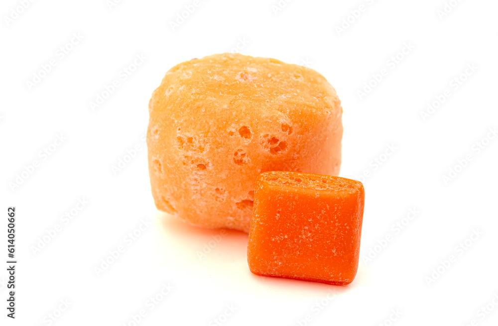 A Freeze Dried Orange Chewy Square Candy and an Original Piece Side by Side on a White Background A Freeze Dried Orange Chewy Square Candy and an Original Piece Side by Side on a White Background