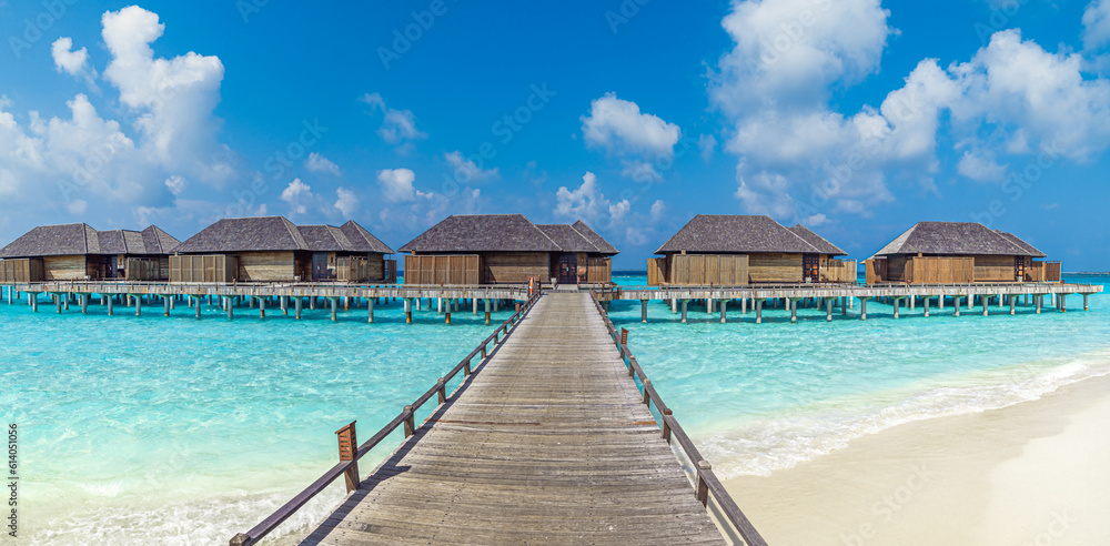 Sunshine panorama at Maldives. Luxury resort villas pier seascape ocean bay white sand blue sky. Beautiful summer landscape. Fantastic beach background for vacation holiday. Paradise island concept