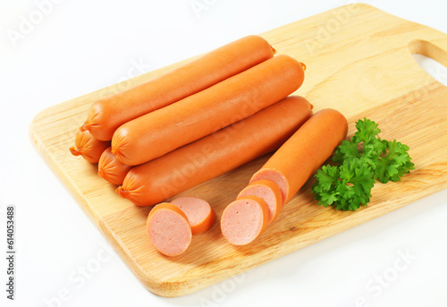 stack of sausages on cutting board