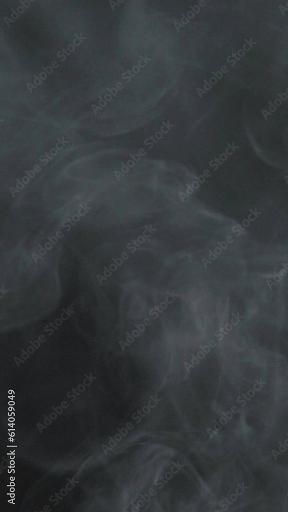 Slow motion vertical video of white smoke, fog, mist, vapor on a black background. Slow motion vertical video of white smoke, fog, mist, vapor on a black background.