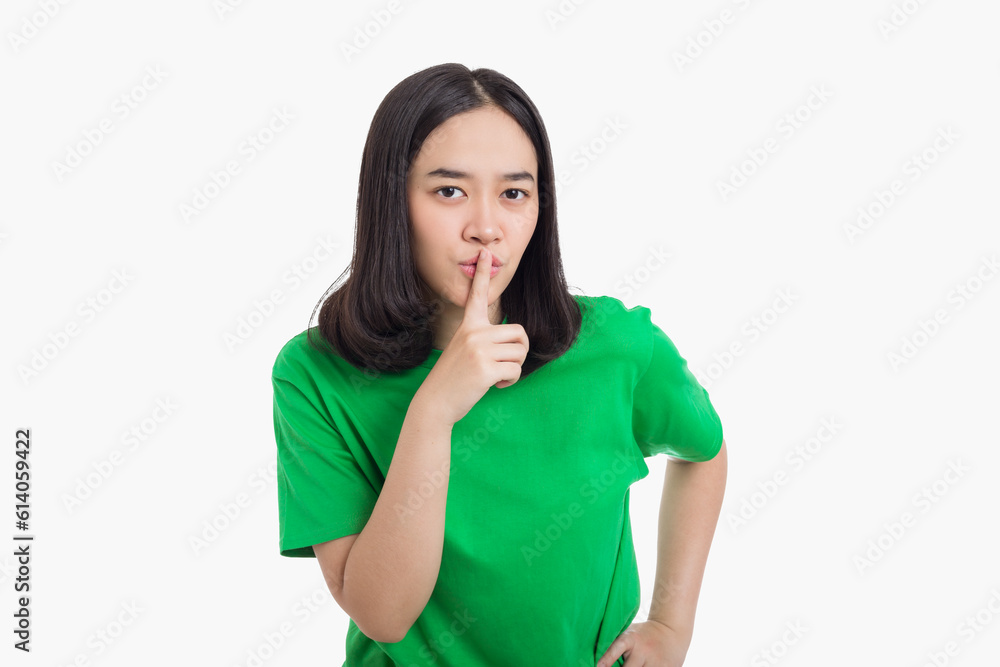 Young Asian woman asking to be silence and quiet gesturing with finger on lips Young Asian woman asking to be silence and quiet gesturing with finger on lips