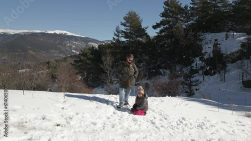 A Mother, Her Daughter and Dog Play at The Snow in Campelles, Girona, Catalonia, Aerial Drone View photo