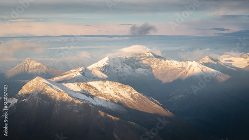 Majestic mountain range with peaks covered by snow during colorful sunset, Austrian Alps, Europe