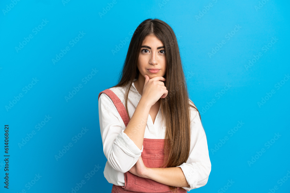 Young caucasian woman isolated on blue background thinking Young caucasian woman isolated on blue background thinking