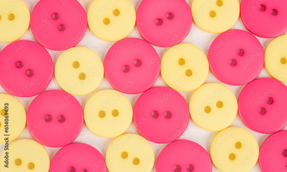 Background from yellow and pink plastic round buttons Background from yellow and pink plastic round buttons