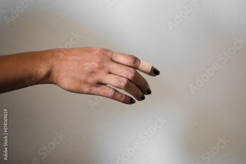 A woman's finger was injured and covered with plaster aid.