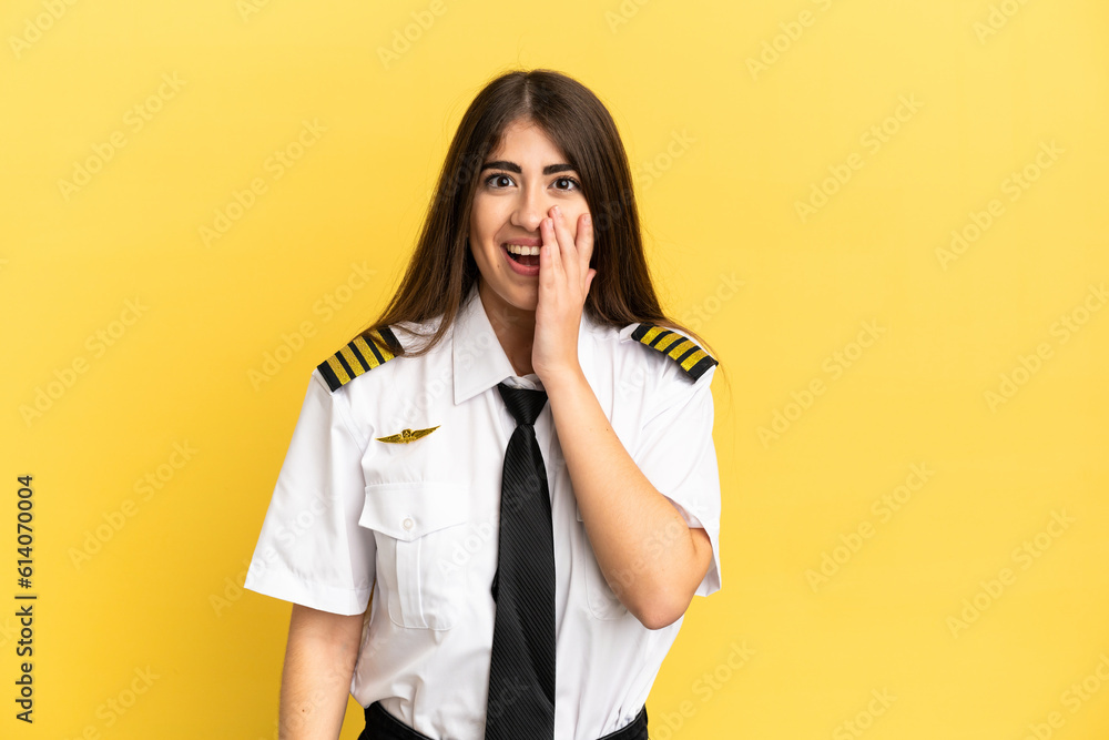 Airplane pilot isolated on yellow background with surprise and shocked facial expression Airplane pilot isolated on yellow background with surprise and shocked facial expression