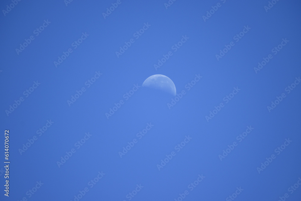 A faintly visible crescent moon in the late afternoon sky. A faintly visible crescent moon in the late afternoon sky.
