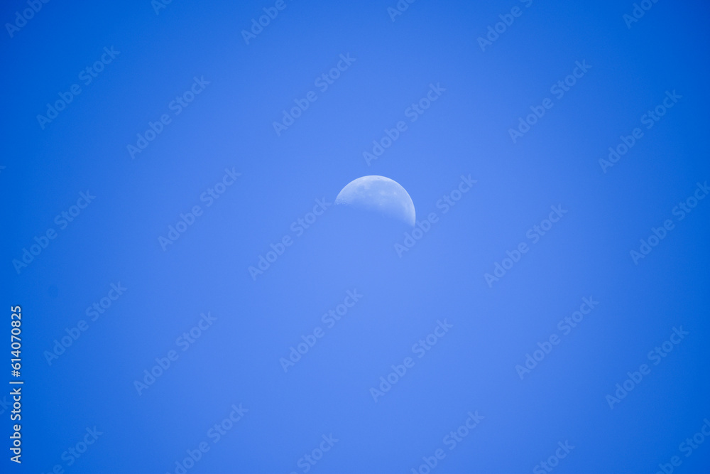 A faintly visible crescent moon in the late afternoon sky. A faintly visible crescent moon in the late afternoon sky.