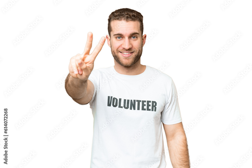 Young volunteer man over isolated chroma key background smiling and showing victory sign Young volunteer man over isolated chroma key background smiling and showing victory sign