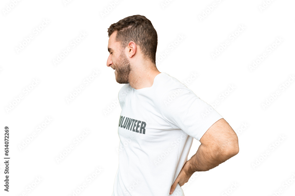 Young volunteer man over isolated chroma key background suffering from backache for having made an effort Young volunteer man over isolated chroma key background suffering from backache for having made an effort