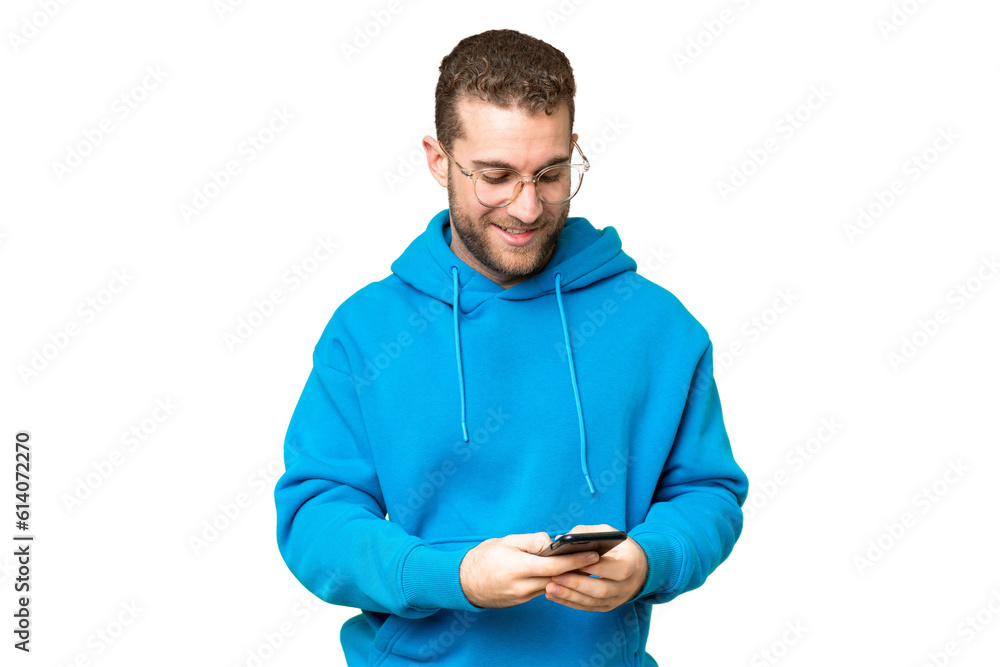 Young handsome blonde man over isolated chroma key background sending a message with the mobile Young handsome blonde man over isolated chroma key background sending a message with the mobile