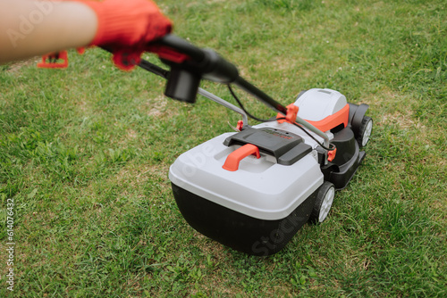 Lawn mover on green grass in modern garden. Machine for cutting lawns. Safety equipment with garden tools