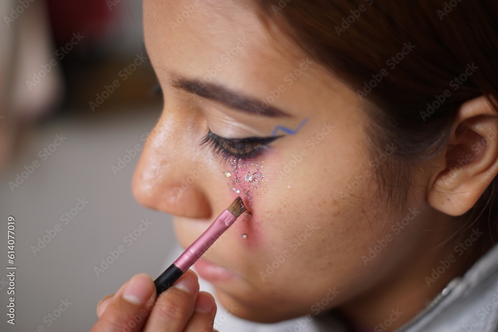 Teenage latin hispanic girl putting on makeup Teenage latin hispanic girl putting on makeup