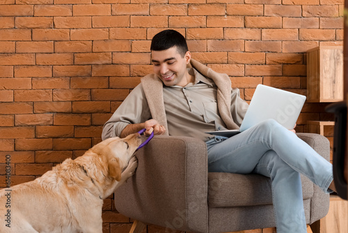 Young man with laptop and c...