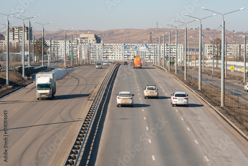 Multi-lane road with a dividing strip against the backdrop of the city.