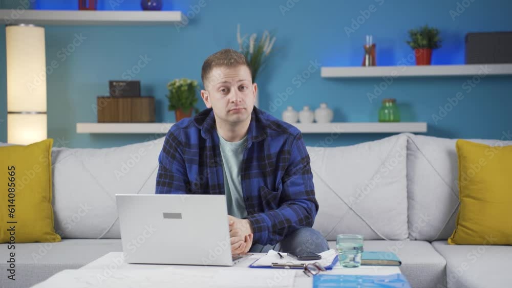 Home office worker man nods to the camera. Home office worker man nods to the camera.